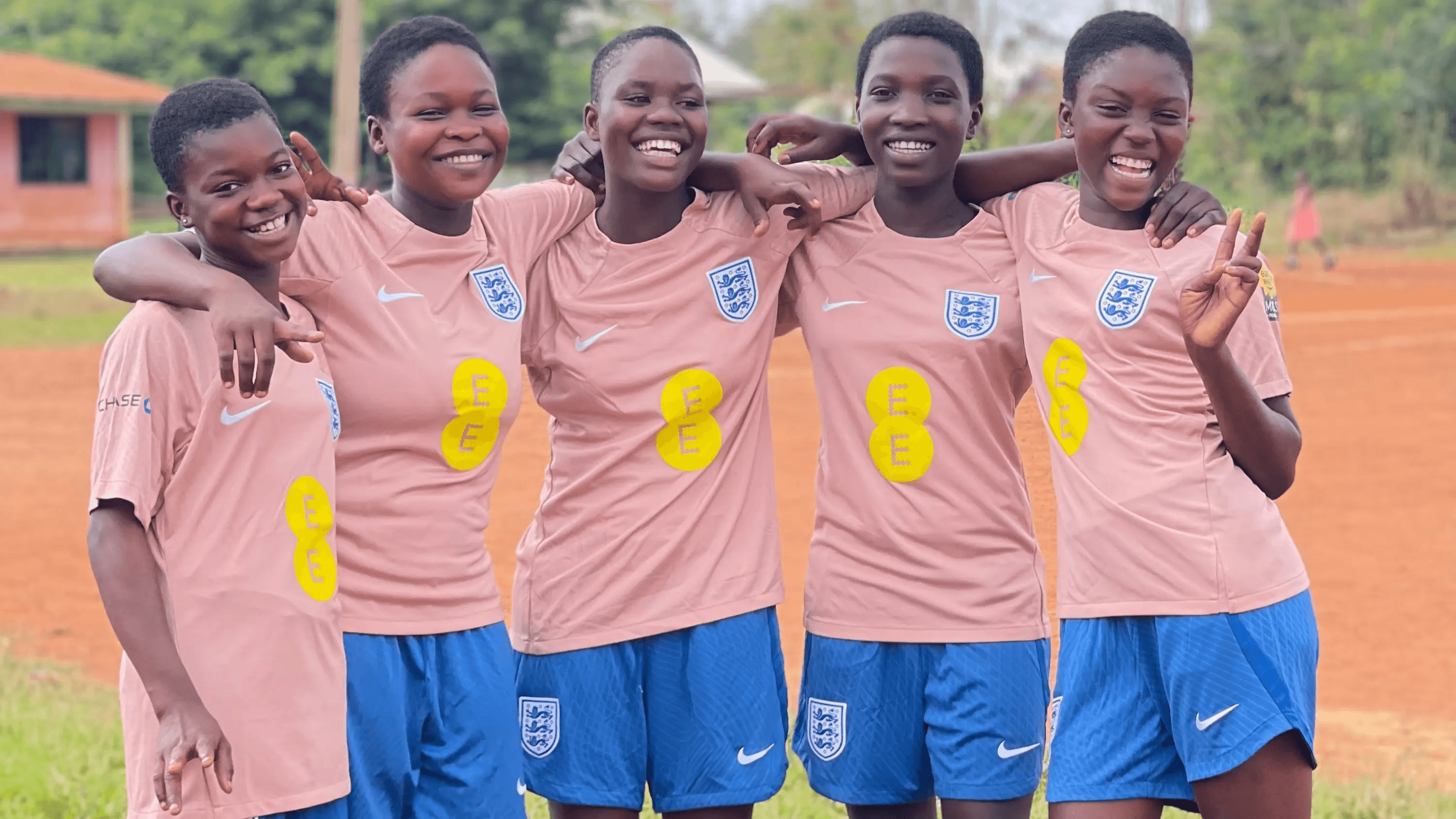 Girls4Goals players smiling in yellow shirts